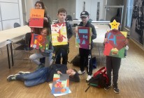 6 Schüler*innen zeigen beim Gruppenfoto ihre gestalteten Werke